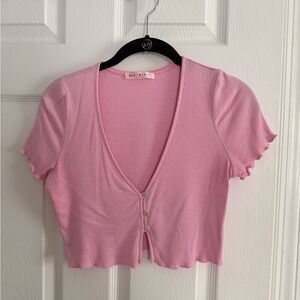 Pink cropped top with button detail. size medium